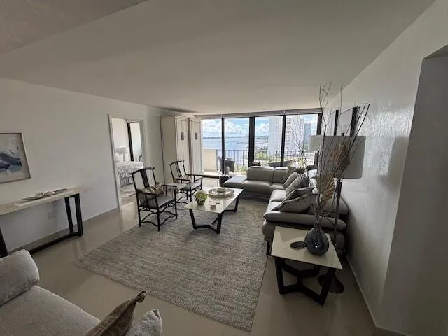 a living room with furniture and large windows