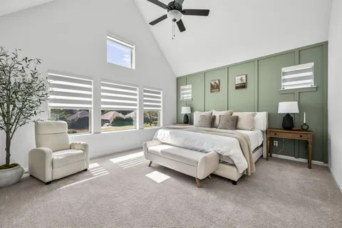 a spacious bedroom with a bed and a couch
