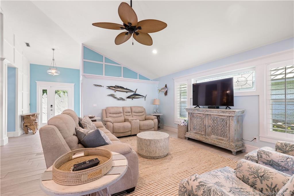 1359 Southwest Dyer Point Road Palm City, FL 34990 - Photo 10 of 55 a living room with furniture and a flat screen tv