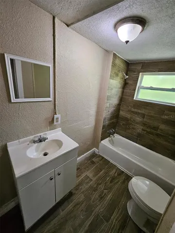 a bathroom with a toilet and a bathtub