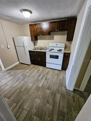a kitchen with a stove top oven and cabinets