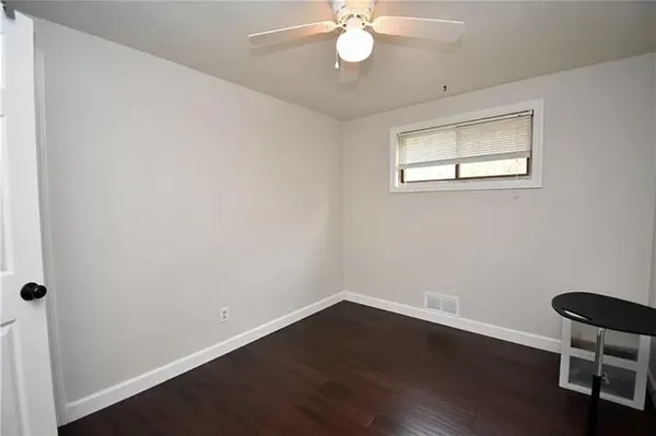 a view of a room with wooden floor and windows