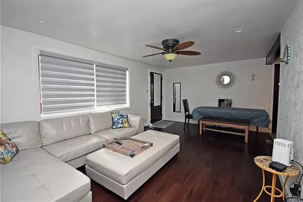 a living room with furniture a window and a table