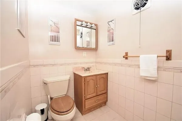 a bathroom with a sink toilet and mirror
