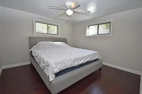 a bed sitting in a bedroom next to a window