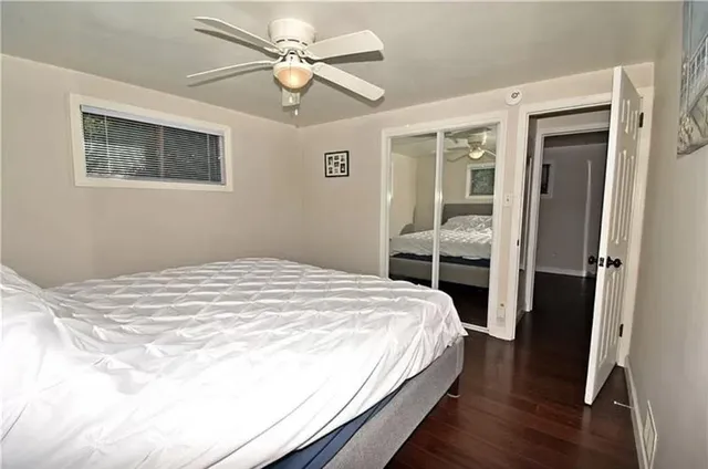 a bedroom with a large bed and a window