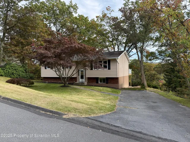 a kitchen with stainless steel appliances granite countertop a sink and a stove