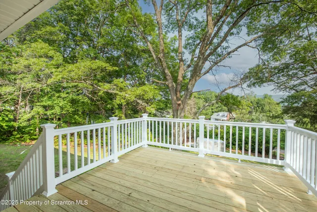 a view of a house with backyard and trees