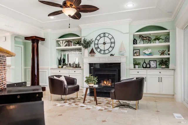 a living room with furniture a clock and a fireplace