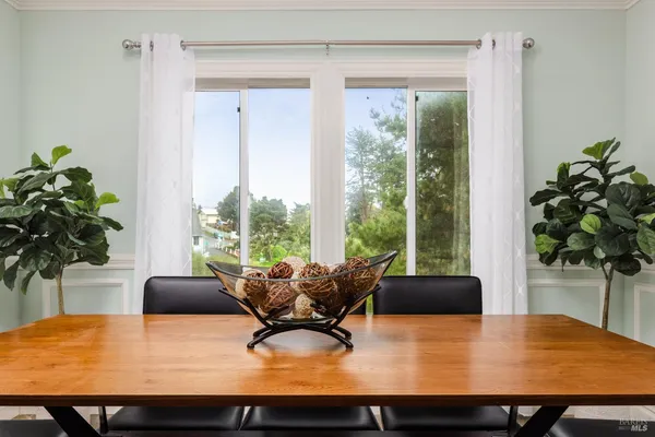 a view of a dining room with furniture and window