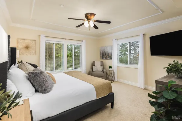 a bedroom with a bed and glass windows