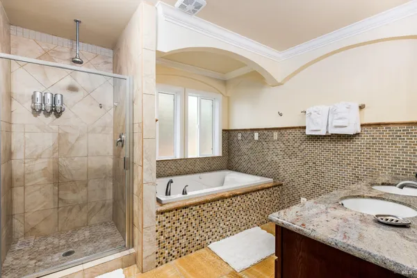 a bathroom with a granite countertop sink a toilet and shower