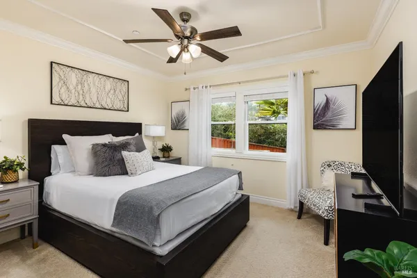 a bedroom with a bed and a flat screen tv