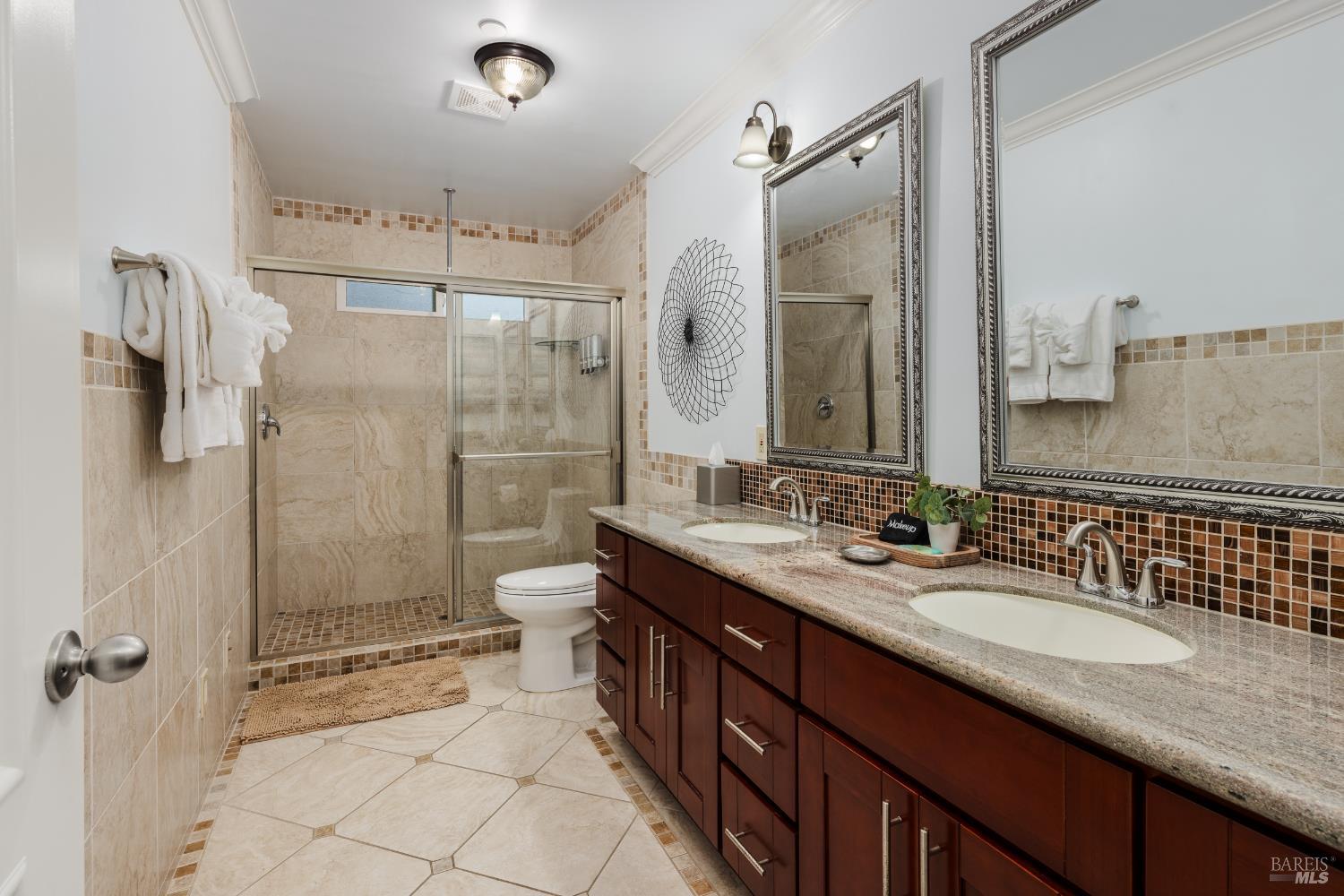 1534 Ranch Road Bodega Bay, CA 94923 - Photo 27 of 33 a bathroom with a double vanity sink toilet mirror and shower