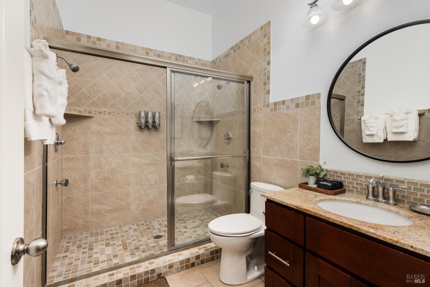 1534 Ranch Road Bodega Bay, CA 94923 - Photo 30 of 33 a bathroom with a granite countertop sink toilet and shower