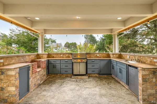 a large kitchen with lots of counter space and wooden floor
