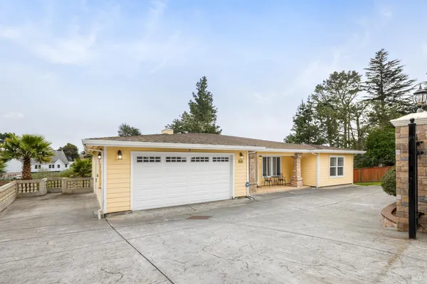 a view of house with outdoor space and parking