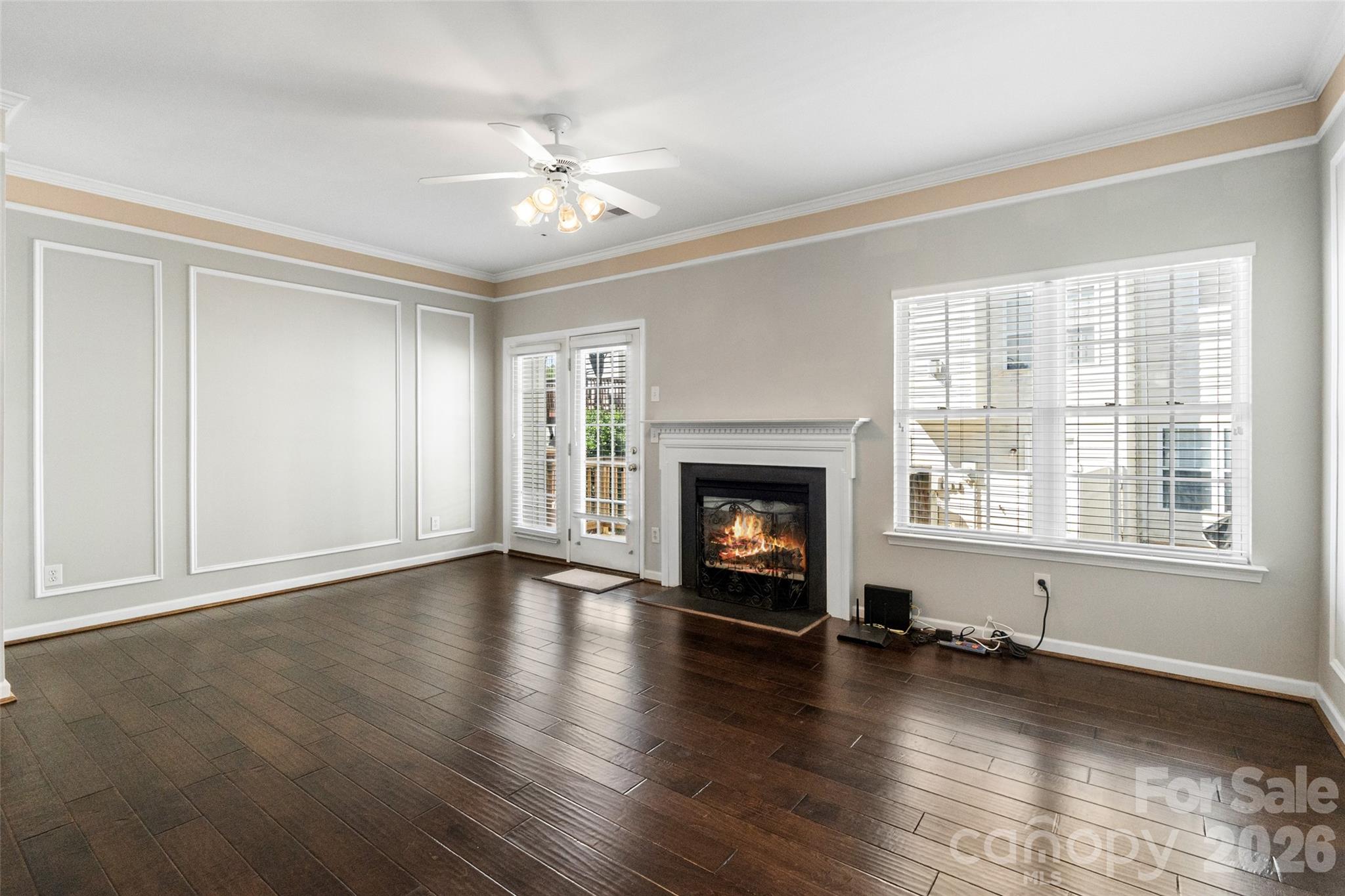 104 Rock Ridge Lane Mount Holly, NC 28120 - Photo 12 of 48 an empty room with wooden floor fireplace and windows
