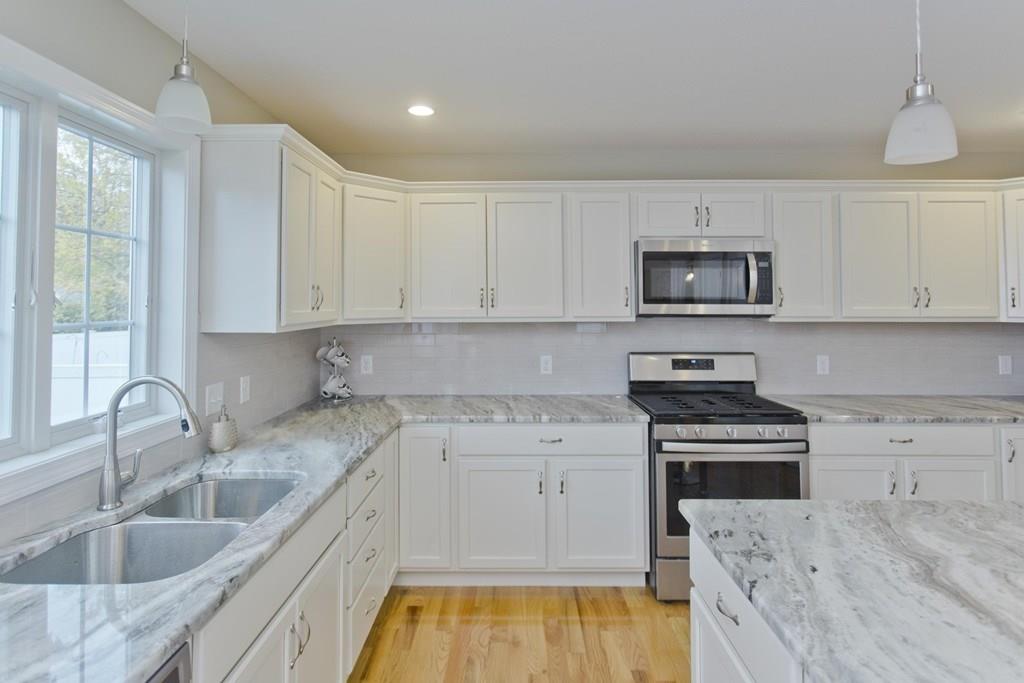 281 Gilbert Avenue Springfield, MA 01119 - Photo 2 of 31 a kitchen with sink a stove and cabinets