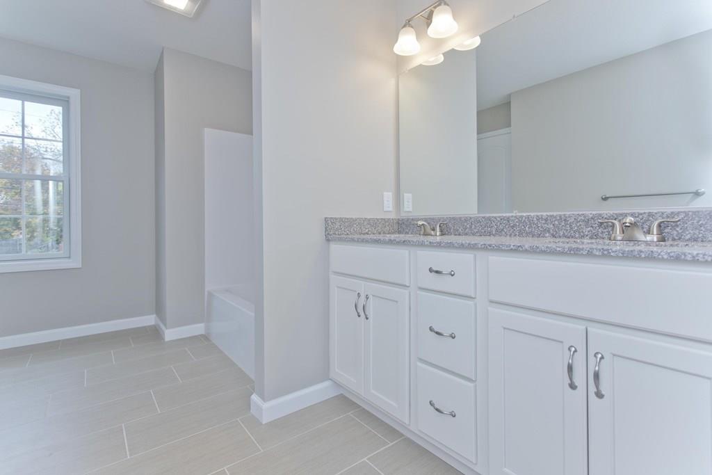 281 Gilbert Avenue Springfield, MA 01119 - Photo 30 of 31 a bathroom with a granite countertop sink and a mirror