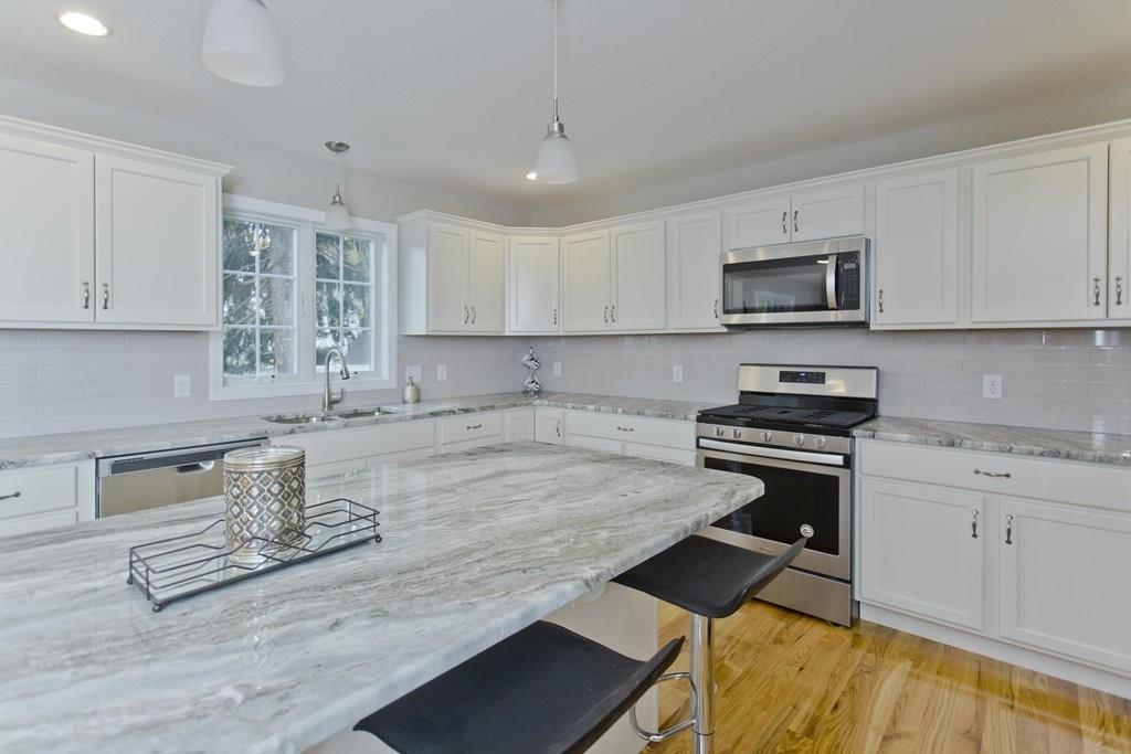 281 Gilbert Avenue Springfield, MA 01119 - Photo 4 of 31 a kitchen with granite countertop a stove a sink and a microwave