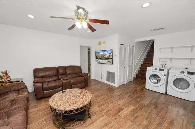 a dining room with furniture and wooden floor
