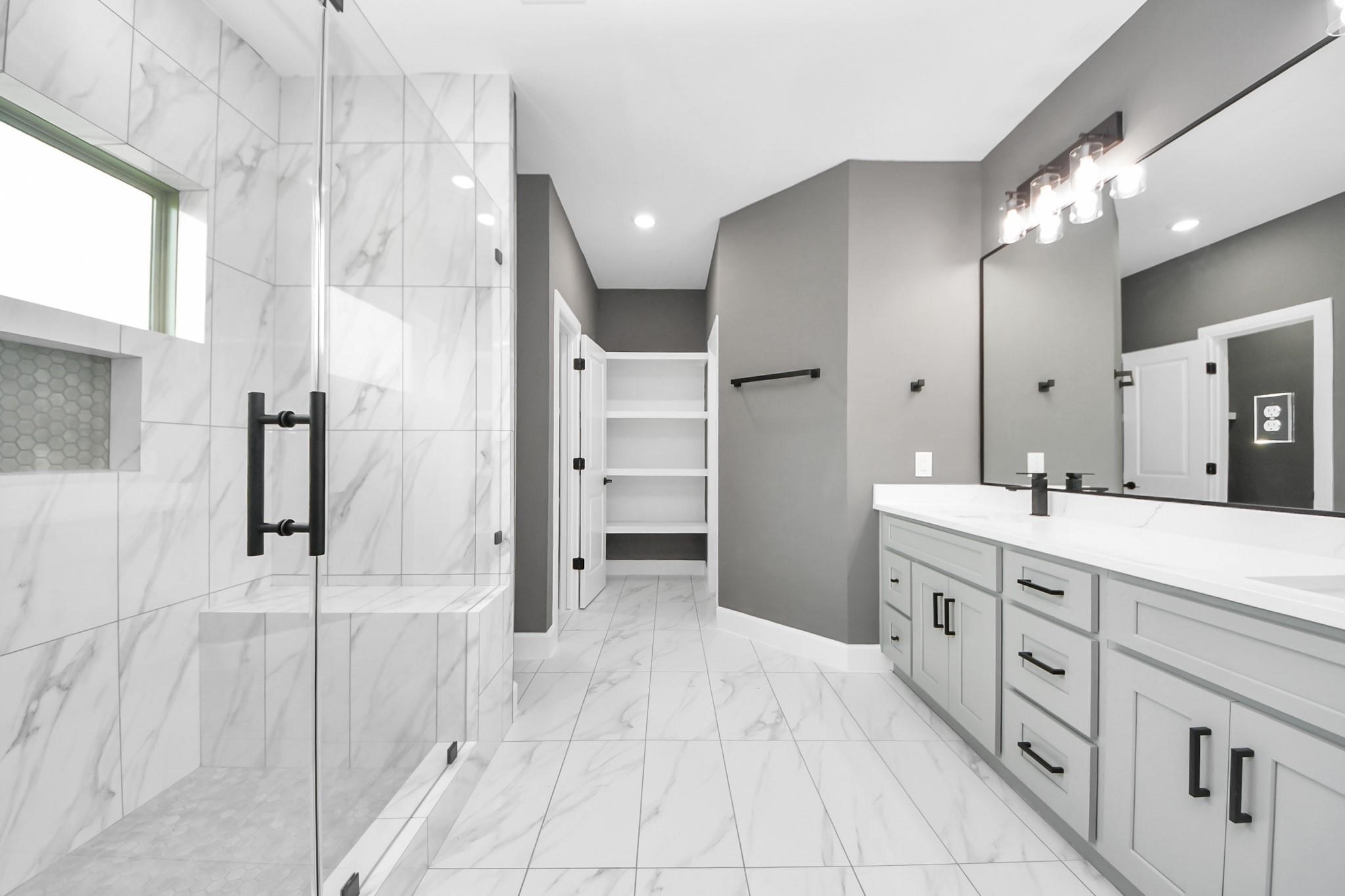 601 Lily Street Prairie View, TX 77484 - Photo 7 of 14 a spacious bathroom with a double vanity sink shower and a mirror