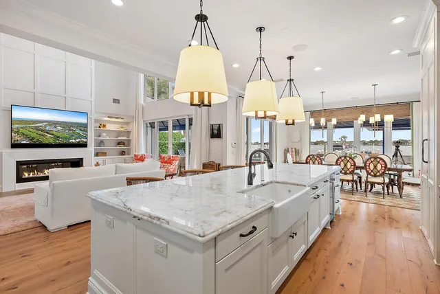 a large living room with kitchen island furniture and a flat screen tv