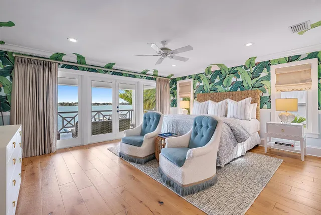 a spacious bedroom with furniture and a wooden floor