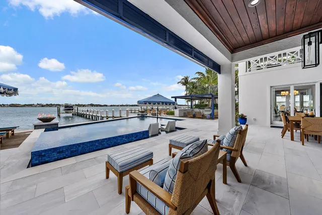 a living room with furniture a rug and a floor to ceiling window