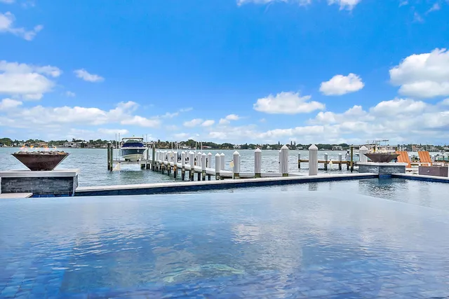 a view of a terrace with seating area and ocean view
