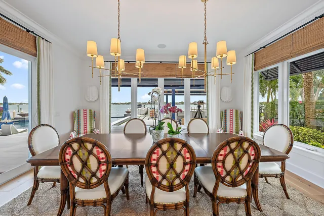a dining room with furniture and a floor to ceiling window