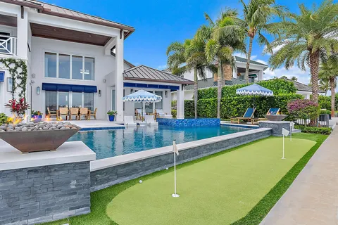 a view of a house with backyard and sitting area
