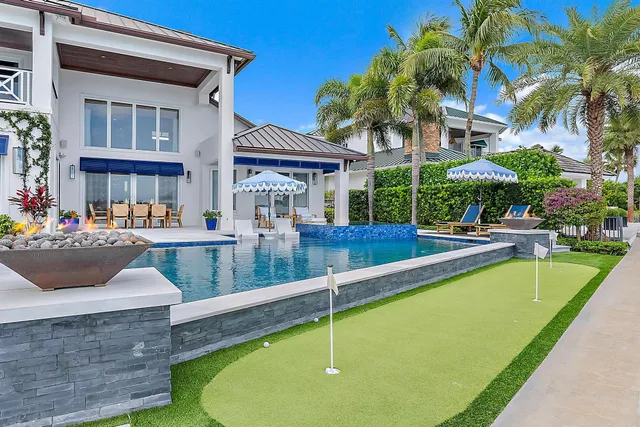 a view of a house with backyard and sitting area