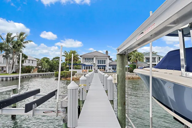 a view of a house with pool and sitting area