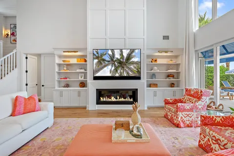 a living room with furniture a fireplace and a flat screen tv