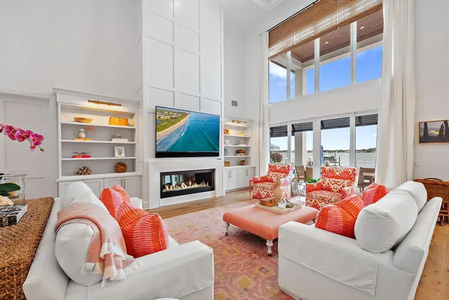 a living room with fireplace furniture and a floor to ceiling window