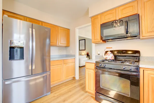 a kitchen with stainless steel appliances granite countertop a refrigerator stove and sink