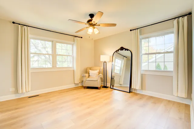 a view of a livingroom with a window and a ceiling fan