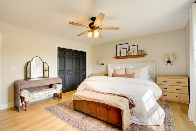 a bedroom with a bed and a chandelier