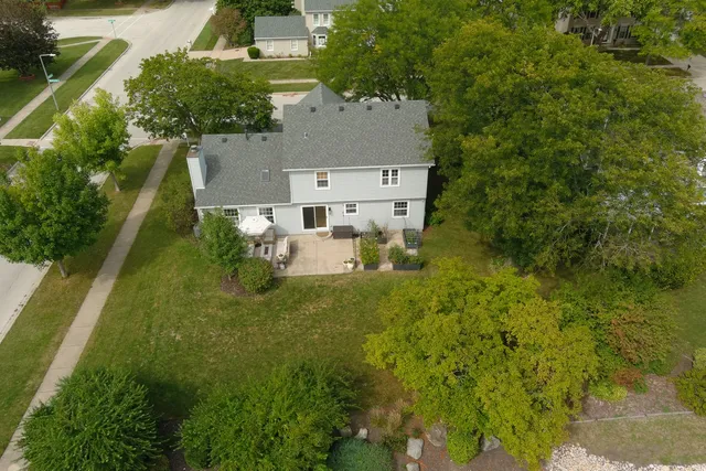 an aerial view of a house with a yard