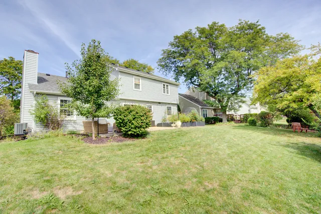 a view of a house with a yard and sitting area