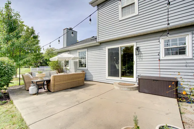 a view of a patio with table and chairs with wooden fence