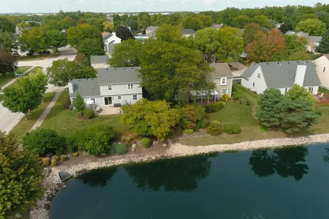 an aerial view of residential house with outdoor space and lake view