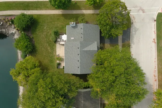 an aerial view of a house with a yard and garden