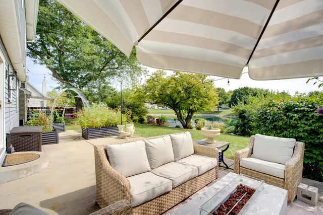 a view of a patio with couches and a big yard