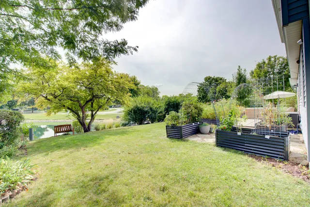 a backyard of a house with barbeque oven and outdoor seating