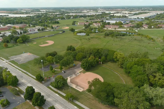 an aerial view of residential houses with outdoor space and river