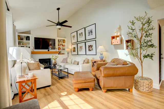a living room with furniture a flat screen tv and a fireplace