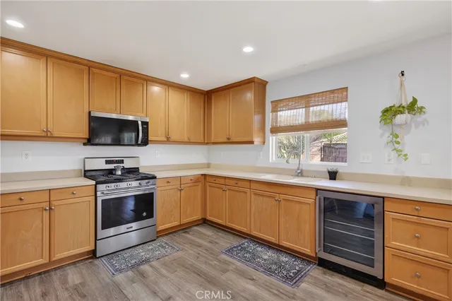 a kitchen with stainless steel appliances granite countertop a sink and stove top oven